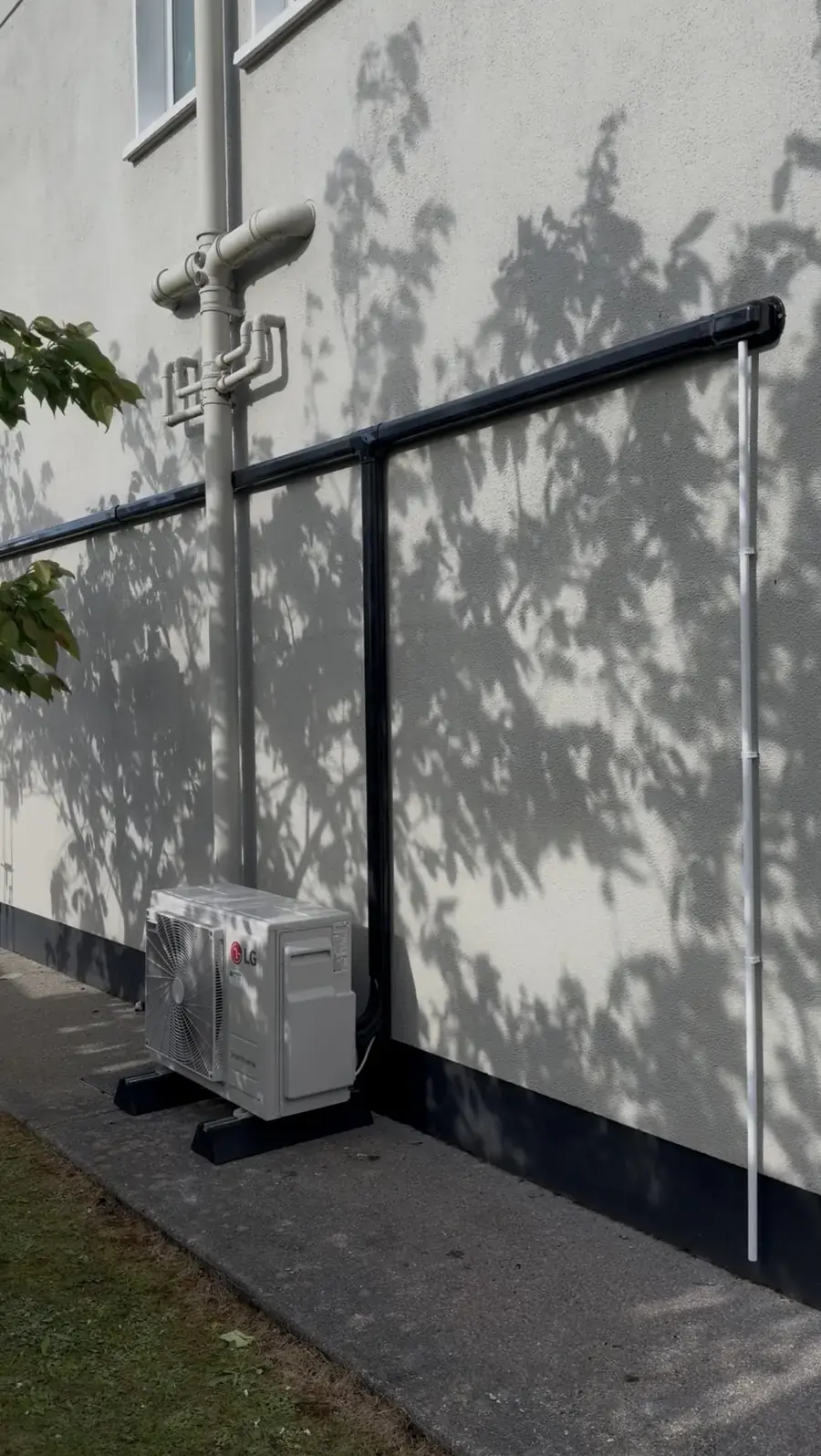 LG outdoor unit with black pipe cover at a Sligo townhouse